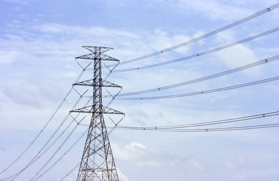 Low angle view of electricity pylon against sky