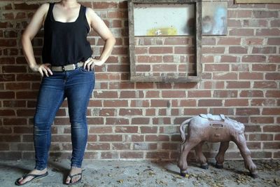 Full length of young woman standing by railing