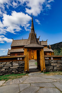 Low angle view of temple by building against sky