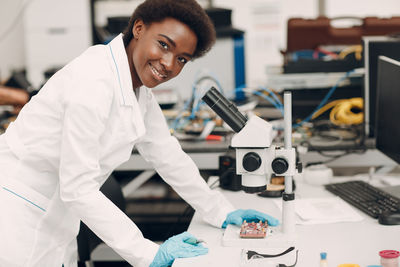 Side view of woman using mobile phone in laboratory