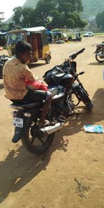 Man riding motorcycle on road