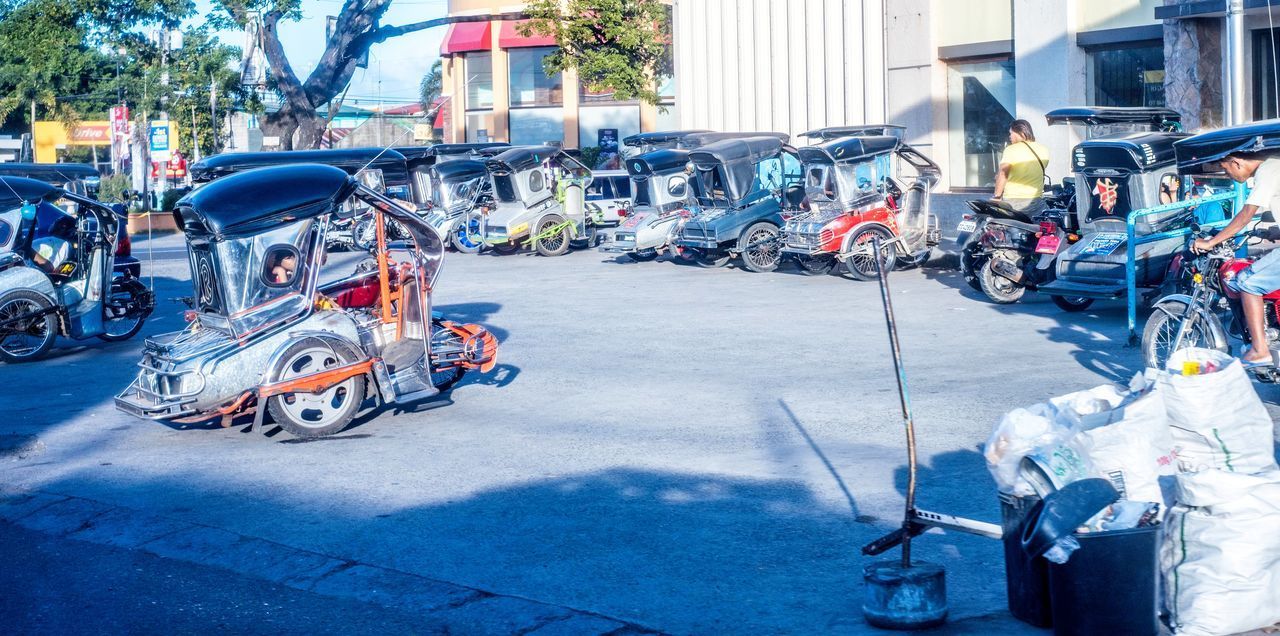 BICYCLES PARKED ON ROAD AGAINST CITY