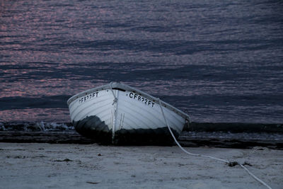 Deck chairs on beach against sea