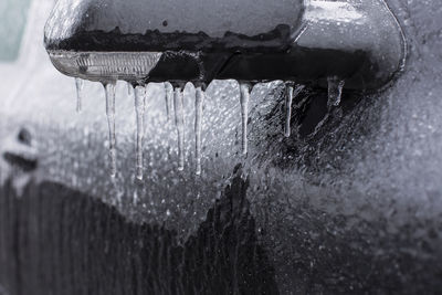 Close-up of water drops on metal during winter