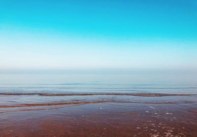 Scenic view of sea against clear blue sky