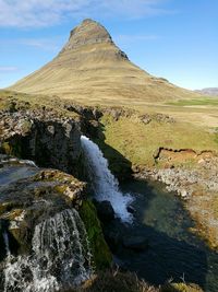 Scenic view of mountain and waterfall at snaefellsnes