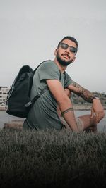 Young man sitting on field