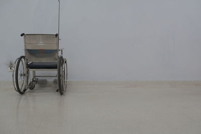 Empty bicycle against wall