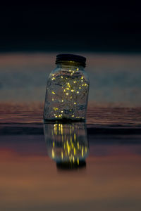 Close-up of glass bottle on table