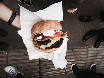 Person holding fresh burger