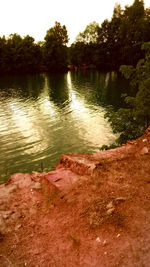 Scenic view of river with trees in background