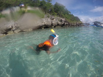 High angle view of mid adult man swimming in sea