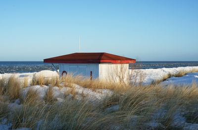 House by baltic sea against clear sky during winter