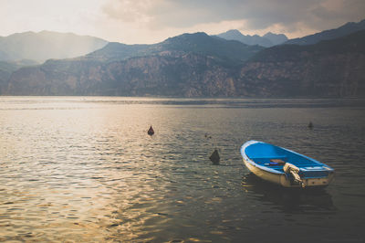 Boat on lake at sunset