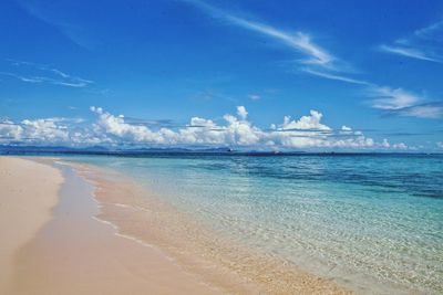 Panoramic view of beach against blue sky