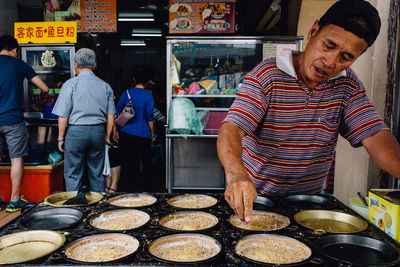 Mature man selling street food