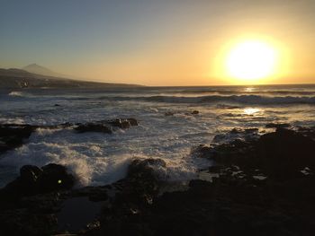 Scenic view of sea against clear sky during sunset