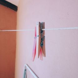 Close-up of clothespins hanging on clothesline at home