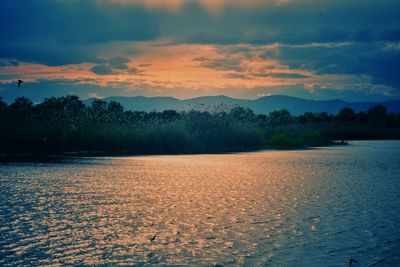 Scenic view of lake against sky during sunset