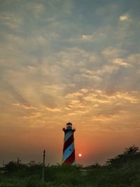 Low angle view of lighthouse against sky during sunset