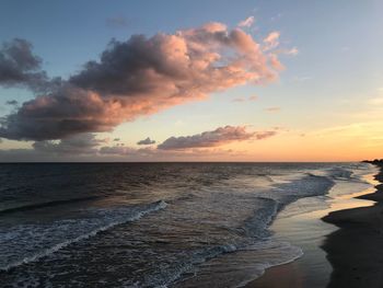 Scenic view of beach against sky during sunset