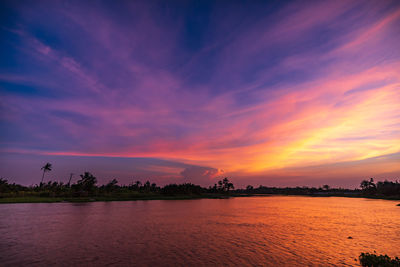 Scenic view of lake against romantic sky at sunset