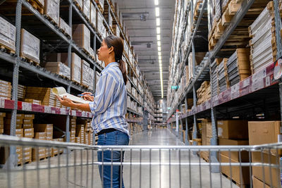 Entrepreneur checking list in warehouse