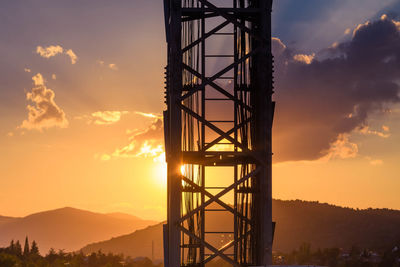 Silhouette tower against sky during sunset