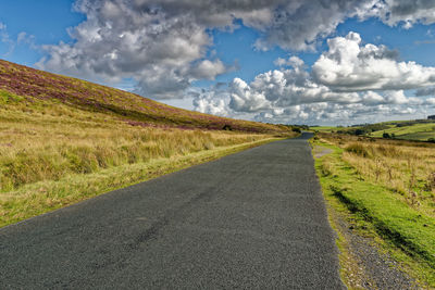 Road amidst landscape against sky