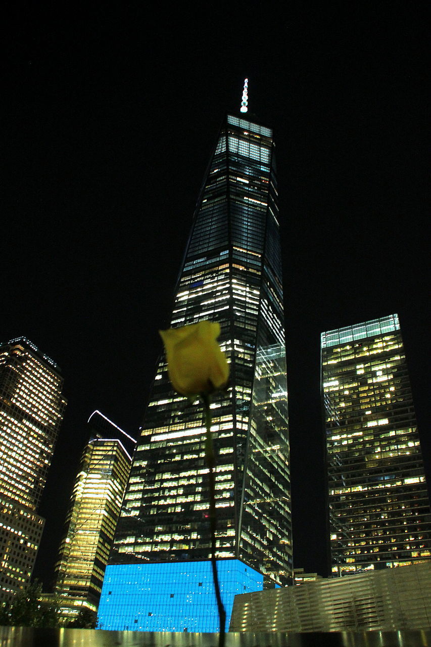 LOW ANGLE VIEW OF ILLUMINATED TOWER AGAINST SKY AT NIGHT