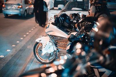 Side view of man sitting on motorcycle at street during night