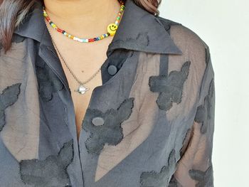 Midsection of woman standing against wall