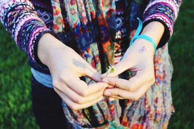 Close-up of cropped hand holding outdoors