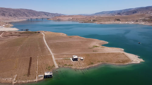 High angle view of land and lake against mountain