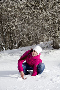 Full length portrait of a girl in snow