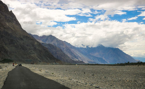 Scenic view of mountains against cloudy sky