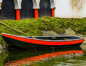 Red boats moored in river