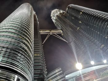 Low angle view of illuminated buildings against sky at night