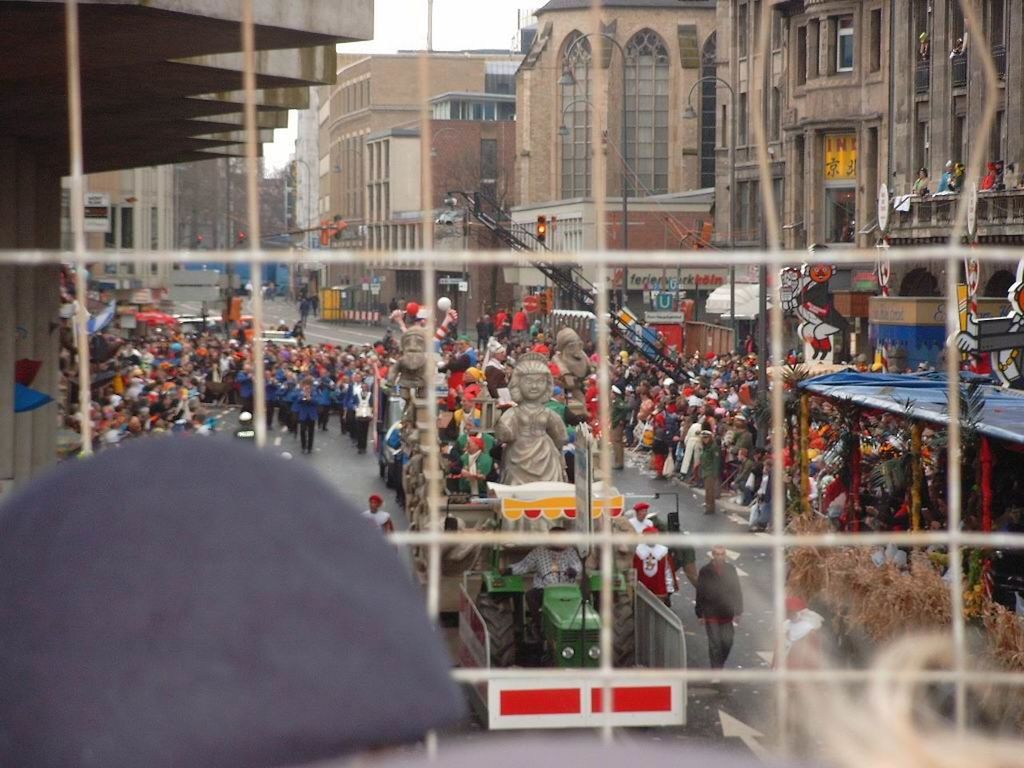 PEOPLE ON CITY STREET IN FRONT OF BUILDINGS