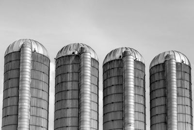 Low angle view of silos against sky