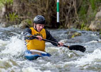 Man kayaking in river