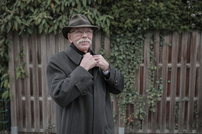 Portrait of man wearing hat standing outdoors