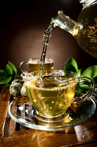 Close-up of mint tea pouring into cup