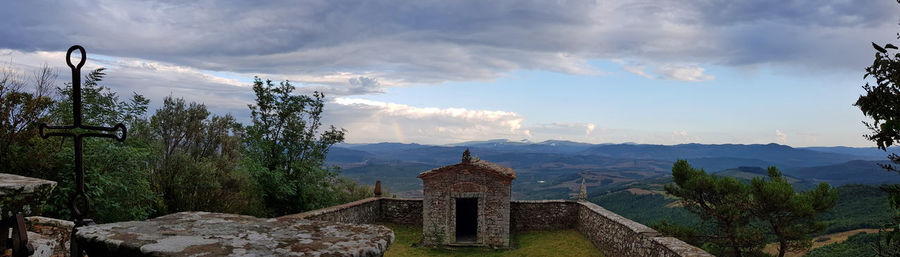 Panoramic view of trees and buildings against sky