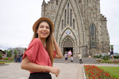 Stylish young woman visiting the town of canela in the serra gaucha region, brazil