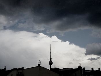 Low angle view of buildings against cloudy sky