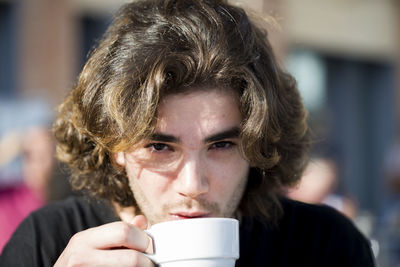 Close-up portrait of man drinking coffee