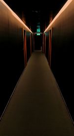 Empty corridor in illuminated building