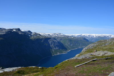 Scenic view of mountains against blue sky