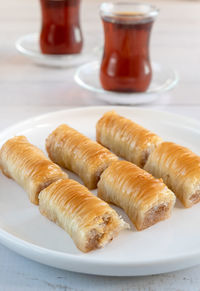 Traditional turkish baklava and a glass of tea. vertical shot.